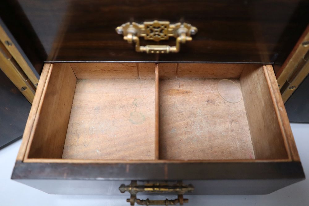 A Victorian coromandel cabinet with three drawers and two doors, with key, 22cm wide